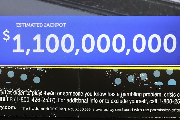 Lottery jackpots are soaring past the billion-dollar mark more frequently, thanks to higher interest rates and several rules changes. Here, a ticket machine displays the projected jackpot for a Mega Millions drawing in Chicago, in early January.