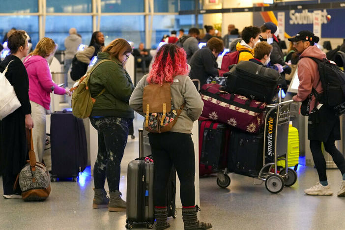 Passengers check in at Southwest Airlines' self-serve kiosks at Chicago's Midway Airport as delays stemming from a computer outage at the Federal Aviation Administration brought flights to a standstill across the U.S. on Wednesday.