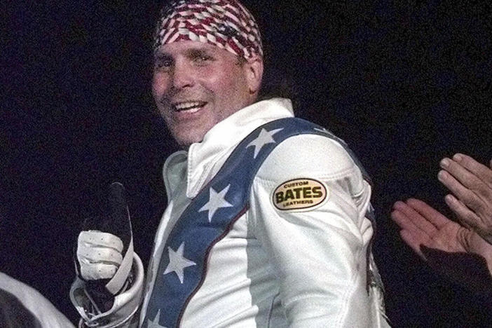 Robbie Knievel gives a thumbs up after jumping a train at the Texas State Railroad Park in Palestine, Texas on Feb. 23, 2000. Knievel, an American stunt performer, died early Friday at a hospice in Reno, Nev.