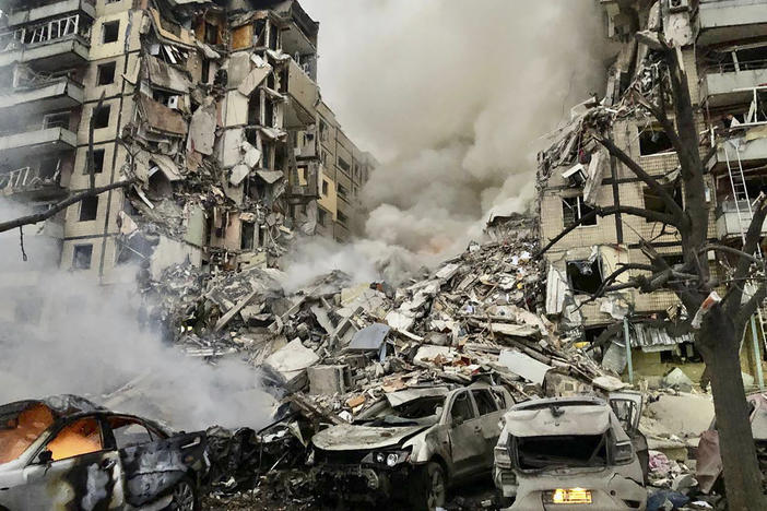 In this photo released by the Dnipro Regional Administration, smoke rises after a Russian rocket hit a multistory building leaving many people under debris in Dnipro, Ukraine, on Saturday.