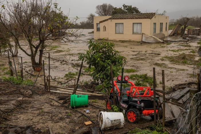 Flood waters inundate a home by the Salinas River near Chualar, Calif., on Saturday. A series of atmospheric river storms continue to cause widespread destruction across the state.