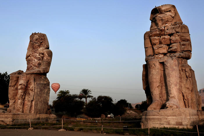 The Colossi of Memnon, two sandstone statues of Amenhotep III, are seen in Luxor in 2017. Excavators say they have discovered a new ancient tomb in the Egyptian city.