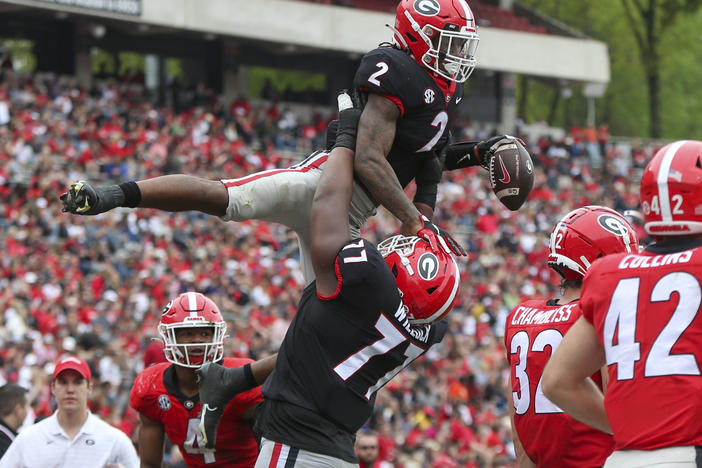 University of Georgia running back Kendall Milton, #2, celebrates after a touchdown with offensive lineman Devin Willock, #77, during the school's spring NCAA college football game on Saturday, April 16, 2022, in Athens.