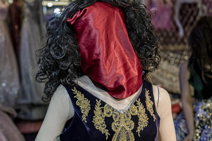 A mannequin's head is covered in a woman dress shop in Kabul, Afghanistan, Monday, Dec. 26, 2022.