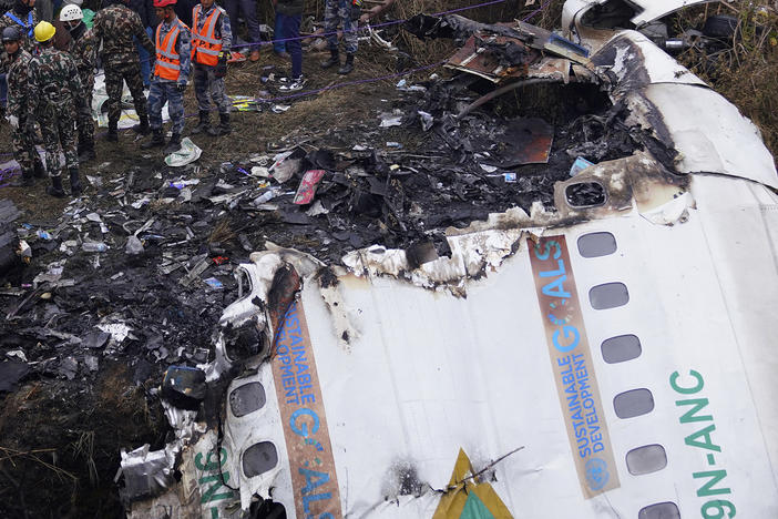 Rescuers scour the crash site and wreckage of a passenger plane in Pokhara, Nepal, Monday, Jan.16, 2023. Nepal began a national day of mourning Monday a day after the plane crashed while attempting to land.