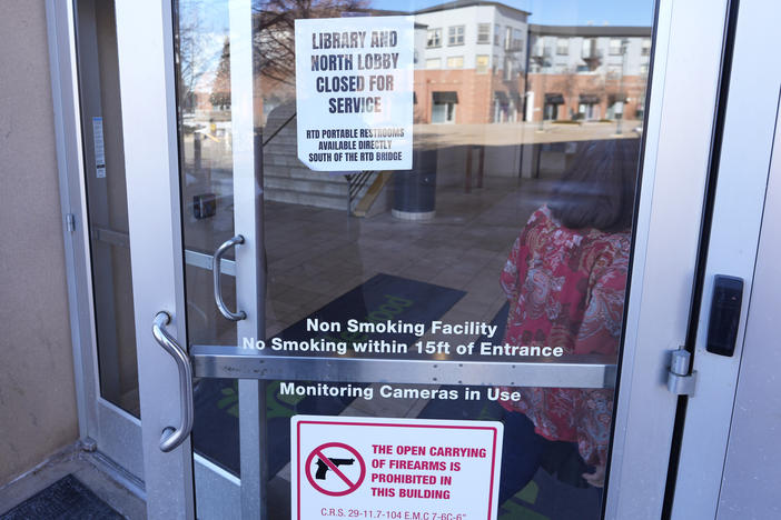 Signs are placed on the outside doors of city hall to advise visitors that the library as well as a restroom are closed because of meth contamination in the south Denver suburb of Englewood, Colo.