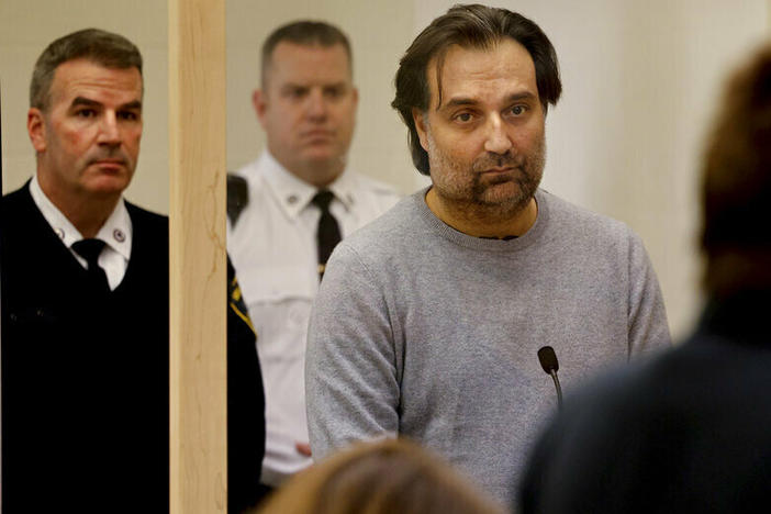 Brian Walshe, center, listens during his arraignment Wednesday at Quincy District Court, in Quincy, Mass., on a charge of murdering his wife Ana Walshe.