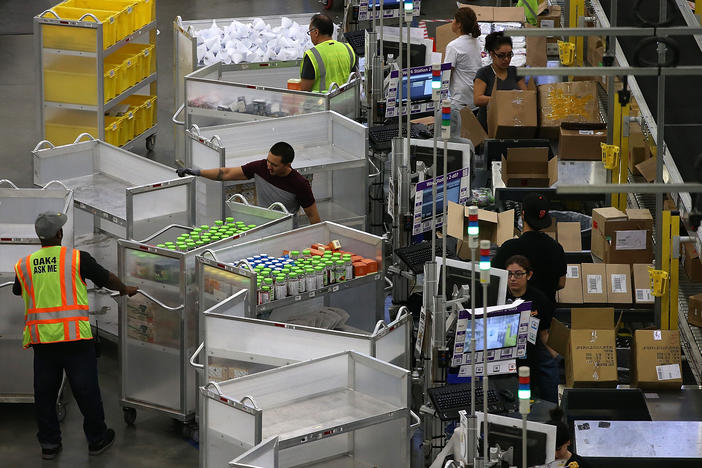 Workers pack orders at an Amazon fulfillment center on January 20, 2015 in Tracy, California. OSHA cited Amazon after federal safety inspectors found ergonomic hazards at three Amazon warehouses.