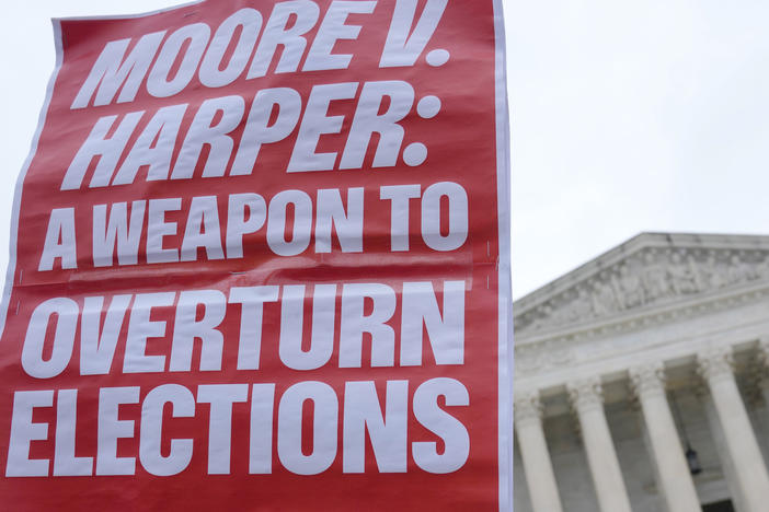 A sign held up by a demonstrator says "MOORE V. HARPER: A WEAPON TO OVERTURN ELECTIONS" at a December rally outside the Supreme Court in Washington, D.C.