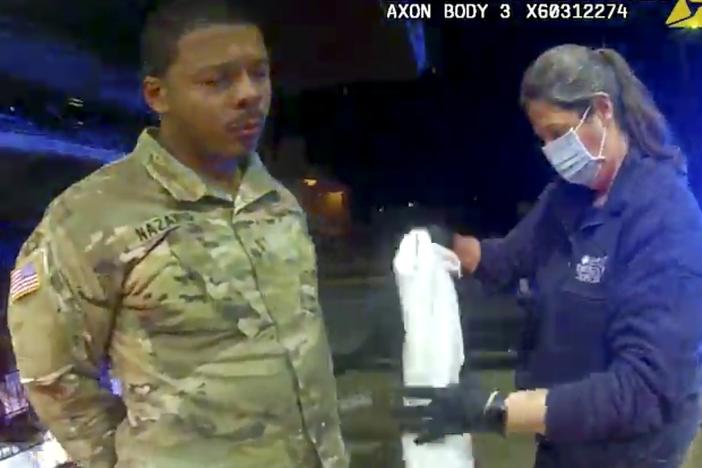 In this image taken from Windsor, Va., police body camera footage, Lt. Caron Nazario is helped by an EMT after he was pepper-sprayed by Windsor police during a traffic stop in Windsor, on Dec. 20, 2020.