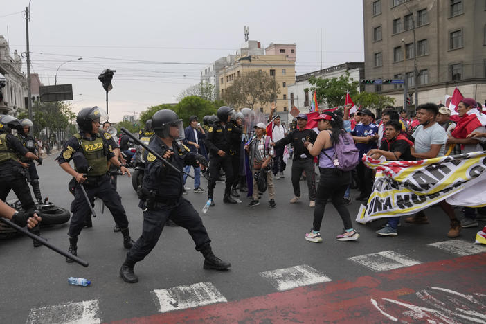 Anti-government protesters who traveled to the capital from across the country march against Peruvian President Dina Boluarte clash with the police in Lima, Peru,  on Wednesday. Protesters are seeking immediate elections, Boluarte's resignation, the release of ousted President Pedro Castillo and justice for the dozens of protesters killed in clashes with police.