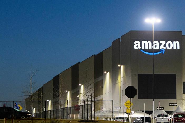An Amazon fulfillment center is seen before sunrise on March 29, 2021, in Bessemer, Ala. Amazon announced it is ending its charity donation program, AmazonSmile.