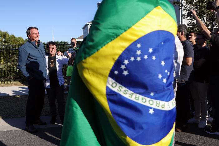 Former President of Brazil Jair Bolsonaro greets supporters on Jan. 17, 2023, outside of a home where he has been staying in Kissimmee, Fla.