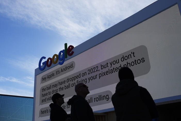 Workers help set up the Google booth at the Las Vegas Convention Center before the start of the CES tech show, Monday, Jan. 2, 2023, in Las Vegas.