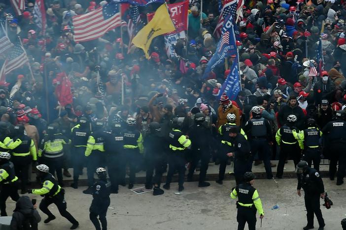 Police hold back supporters of US President Donald Trump as they gather outside the US Capitol's Rotunda on January 6, 2021, in Washington, DC.