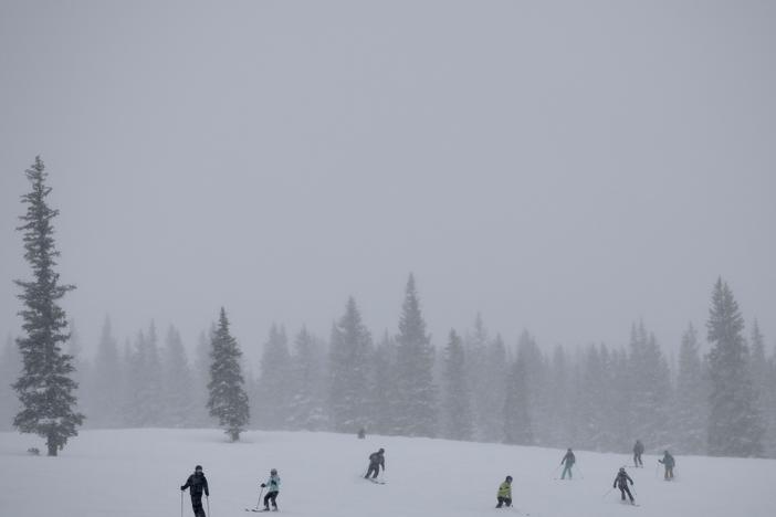 Skiers cruise down the slopes at Snowmass ski area in Colorado. This winter has already delivered snow totals above 130% of average, but climate scientists say it will take more than one wet winter to pull the arid West out of a 23-year drought.