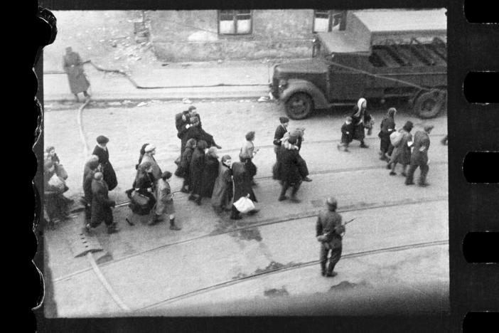 This handout negative dated on April 20, 1943, and taken by Polish firefighter Zbigniew Leszek Grzywaczewski shows Jewish people being evacuated from the Warsaw Ghetto.