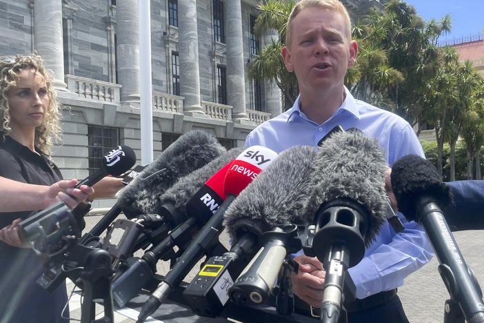 New Zealand Education Minister Chris Hipkins talks to reporters outside Parliament in Wellington, New Zealand, on Saturday.