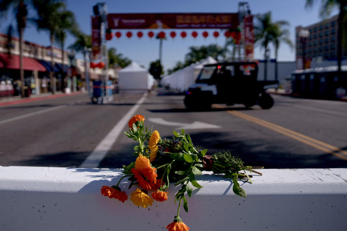 Flowers are placed near the scene of a deadly mass shooting in Monterey Park, Calif., on Sunday.