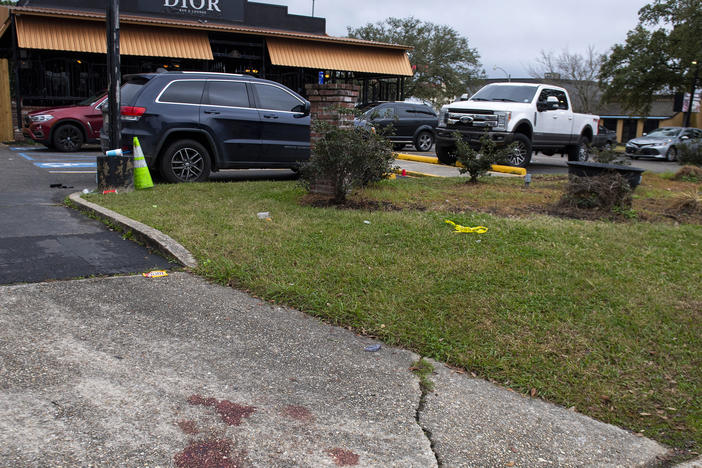 Blood stains and a small section of police tape show the scene where multiple people were injured following an overnight shooting at the Dior Bar & Lounge in Baton Rouge, La., on Sunday, Jan. 22, 2023.