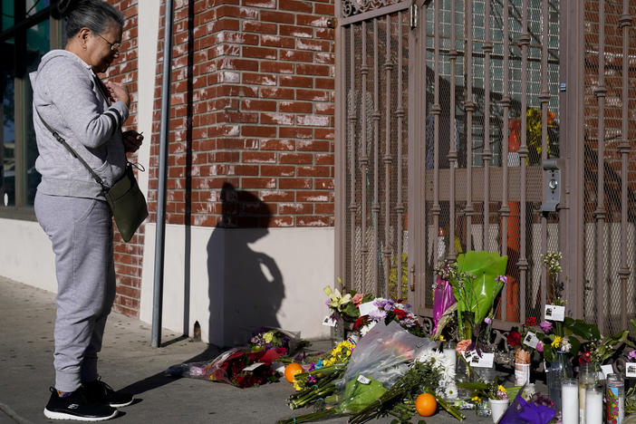 Eleven people were killed and nine more were injured at a dance studio near a Lunar New Year celebration on Saturday night. Here, a woman is seen praying for victims outside Star Dance Studio in Monterey Park, Calif., on Monday.