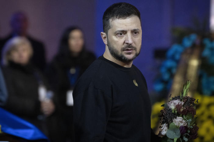 Ukrainian President Volodymyr Zelenskyy pays his respects to victims of a deadly helicopter crash during a farewell ceremony in Kyiv, Ukraine, on Jan. 21.