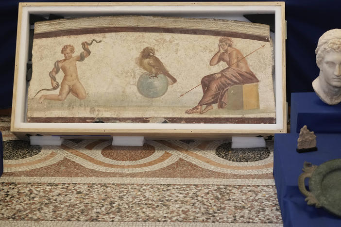 A Pompeiian style fresco from Herculaneum titled "Young Hercules and the snake", dated to the I second A.C., is seen on display among other archaeological artifacts stolen from Italy and sold in the U.S. by international art traffickers, during a press conference in Rome, Monday, Jan. 23, 2023.