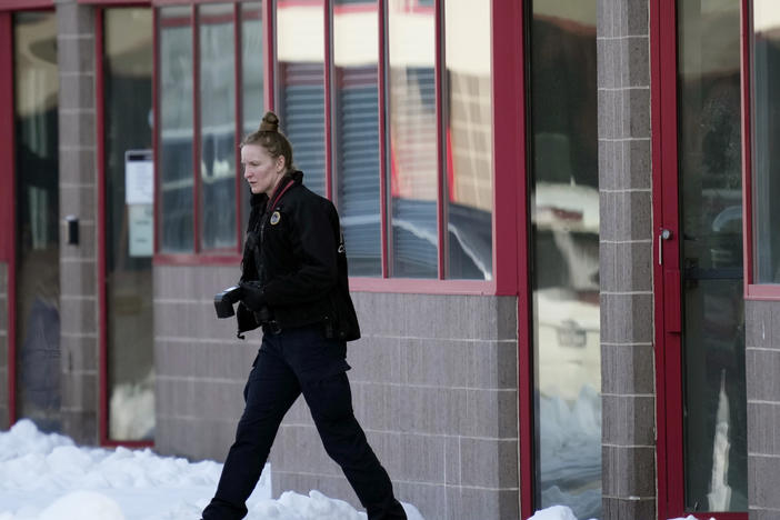 A law enforcement officer exits the Starts Right Here building, Monday, Jan. 23, 2023, in Des Moines, Iowa. Police say two students were killed and a teacher was injured in a shooting at the Des Moines school on the edge of the city's downtown.