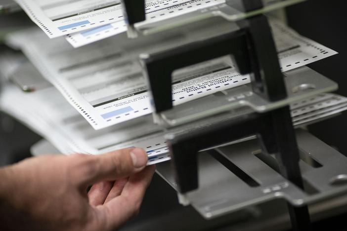 Workers sort absentee ballots in Kenosha, Wis.