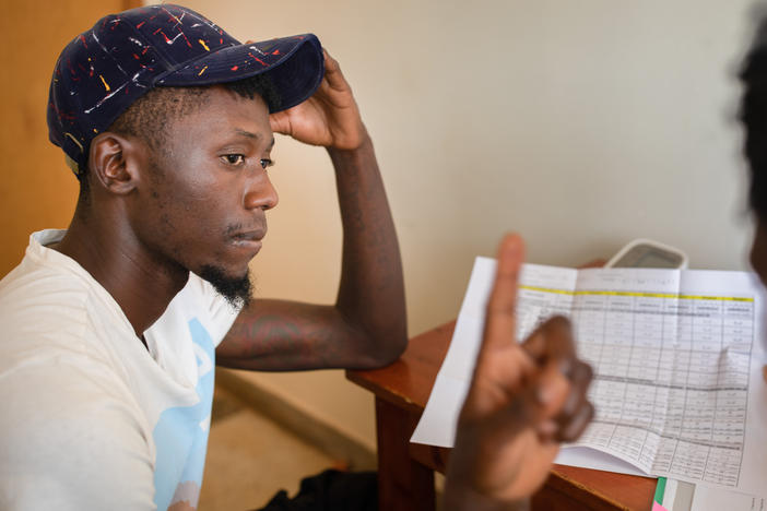 A nurse enrolls a participant in an HIV vaccine trial in Masaka, Uganda, an African-led project.