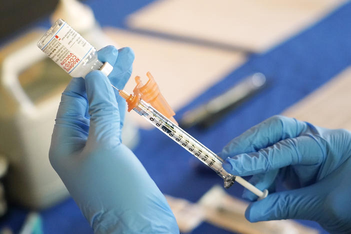 A nurse prepares a syringe of a COVID-19 vaccine at an inoculation station in Jackson, Miss., in 2022. An advisory committee for the FDA voted Thursday to simplify the country's approach to COVID vaccination.