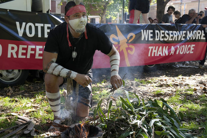 Aboriginal man Josh Sly of the Muggera Dancers prepares a fire for a smoking ceremony at the start of an Invasion Day rally in Sydney, Thursday, Jan. 26, 2023.