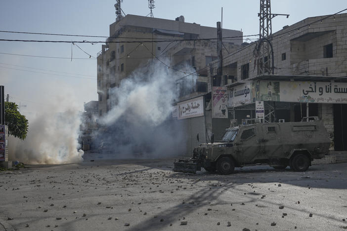 Palestinians clash with Israeli forces following an army raid in the West Bank city of Jenin, on Thursday.