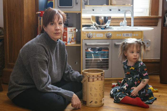 Brenna Kearney plays with her daughter, Joey, at home in Chicago. When Kearney was pregnant, she developed a rare type of preeclampsia and had to undergo an emergency cesarean section. Joey was discharged after a 36-day stay in the NICU.