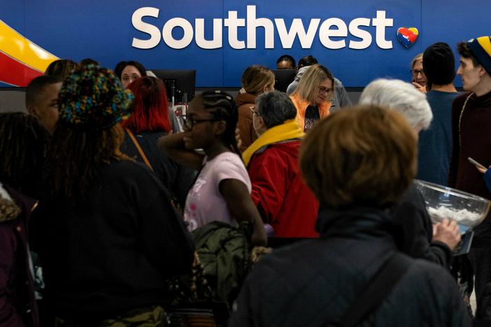 Travelers wait in line at the Southwest Airlines ticketing counter at Nashville International Airport after the airline canceled thousands of flights in Nashville, Tenn., on Dec. 27, 2022. The Department of Transportation is investigating the disaster, which led to $220 million in losses for Southwest