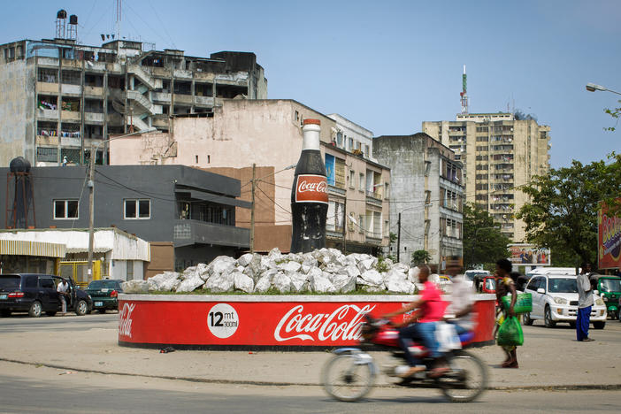As soda consumption has dropped in the West, companies are making an effort to woo new customers in other places. This Coke bottle ad is in Mozambique.