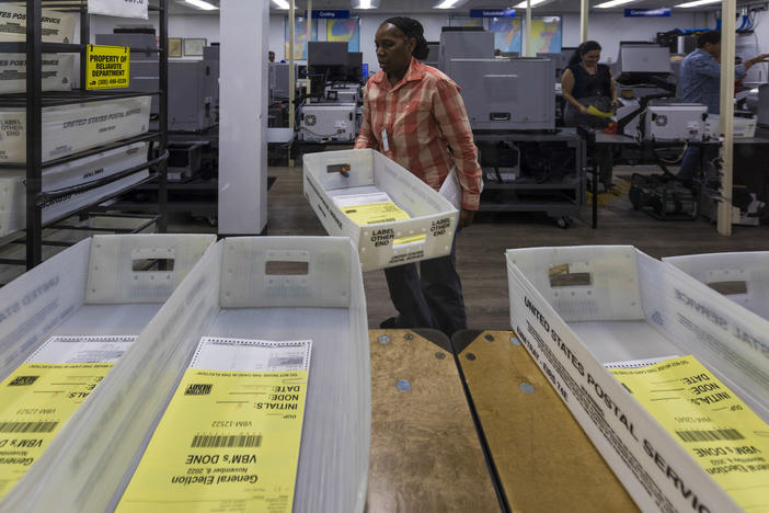 Miami-Dade County elections workers begin counting Florida mail ballots on Nov. 8, 2022.