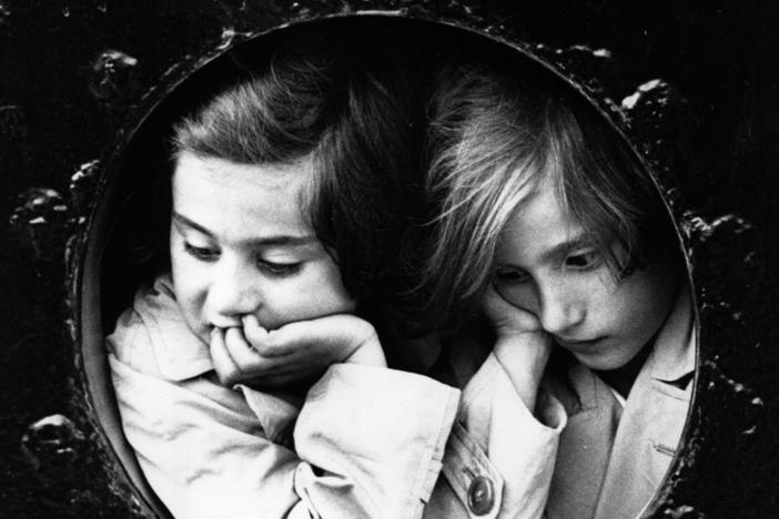 Two young German-Jewish refugees at the porthole of the liner St. Louis finally arrive at Antwerp, after being refused entry to Cuba and Miami prior to the start of World War II.