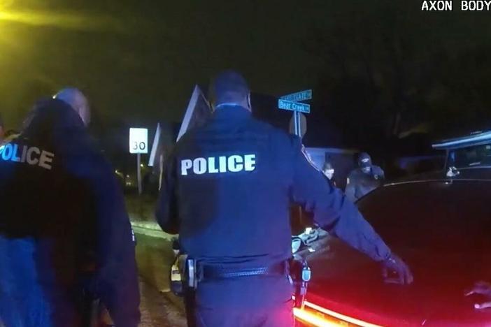 Police officers, who were seen on camera beating and kicking Tyre Nichols, stand by where Nichols is slumped over on the ground. This image is a screenshot of one of the videos from graphic police body camera footage released to the public on Friday night.