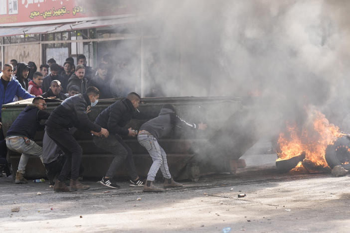 Palestinians clash with Israeli forces following an army raid in the West Bank city of Jenin on Thursday.