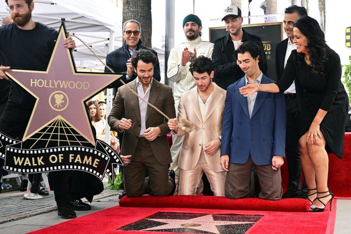 The Jonas Brothers react as their Hollywood Walk of Fame Star is unveiled during a ceremony on Monday in Hollywood, Calif. At the ceremony, they announced their sixth album will be released on May 5.