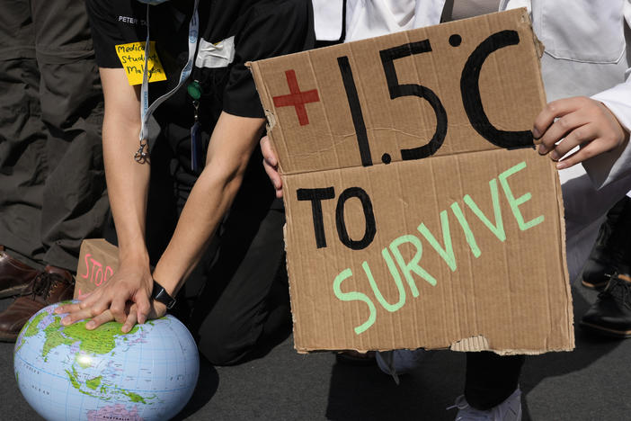 Demonstrators pretend to resuscitate the Earth while advocating for the 1.5 degree warming goal to survive at the COP27 U.N. Climate Summit, Nov. 16, 2022, in Sharm el-Sheikh, Egypt.