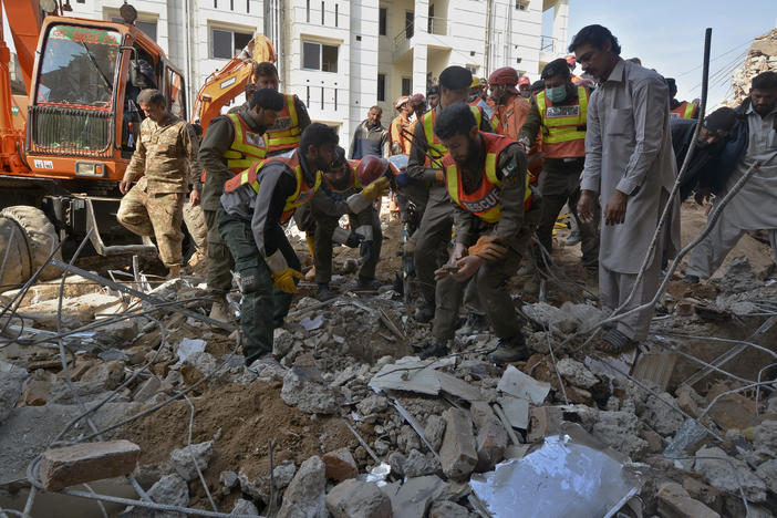 Security officials and rescue workers conduct an operation on Tuesday to clear the rubble and search for bodies at the site of Monday's suicide bombing in Peshawar, Pakistan. The assault on a mosque inside a major police facility was one of the deadliest attacks in Pakistan in recent years.
