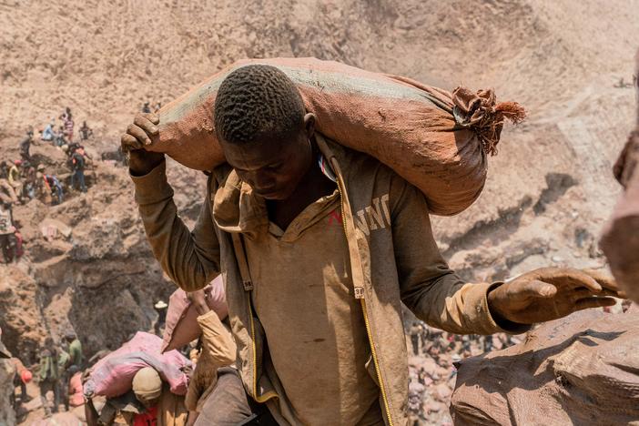 An artisanal miner carries a sack of ore at the Shabara artisanal mine near Kolwezi, DRC, on Oct. 12, 2022.