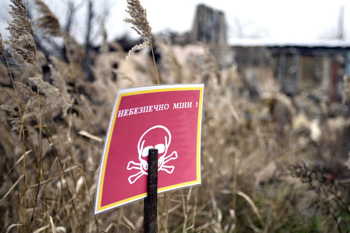 A "Danger Mines!" sign is pictured in Izium, Ukraine.