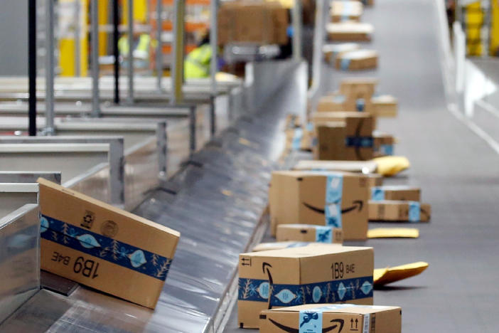 Amazon packages move along a conveyor at an Amazon warehouse in Arizona.