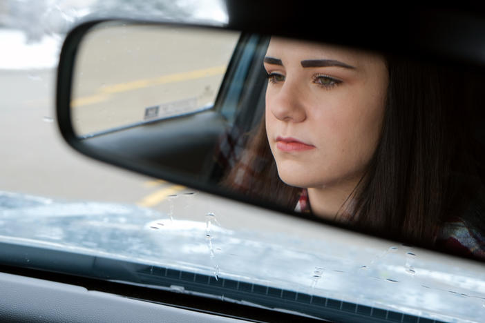 Kaitlyn Arland drives in her car in Junction City, Kan. Two years ago, when she tried to buy her first car, the dealership called her back and demanded she sign a new deal with a higher down payment after she had taken the car home. This tactic is often referred to as a yo-yo deal.