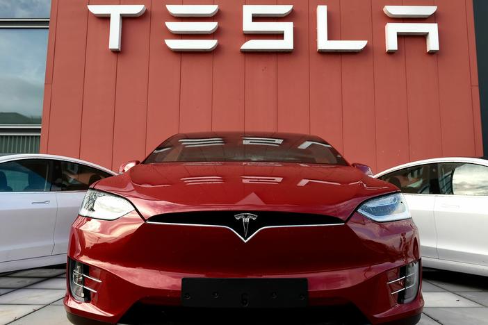 A Tesla car is displayed at a showroom and service center for the auto maker in Amsterdam on Oct. 23, 2019. Tesla recently cut prices across the board, a move with big potential ramifications for the automaker as well as for the industry.