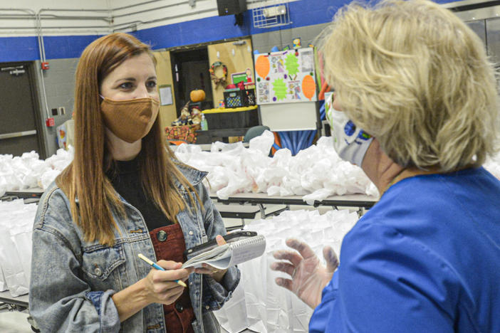 West Virginia Public Broadcasting dismissed part-time reporter Amelia Ferrell Knisely after she covered allegations of the mistreatment of people with disabilities in the state's care. Knisely (left) is shown reporting in this 2021 photograph.