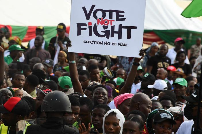 A Labour Party supporter holds a placard during a campaign rally at Adamasingba Stadium in Ibadan, southwestern Nigeria.